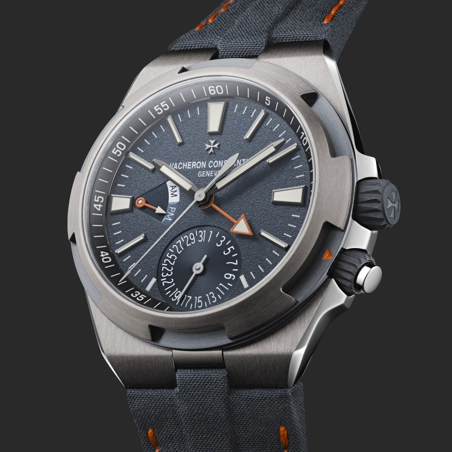 Close-up of a Vacheron Constantin chronograph watch with a textured black dial and fabric strap.