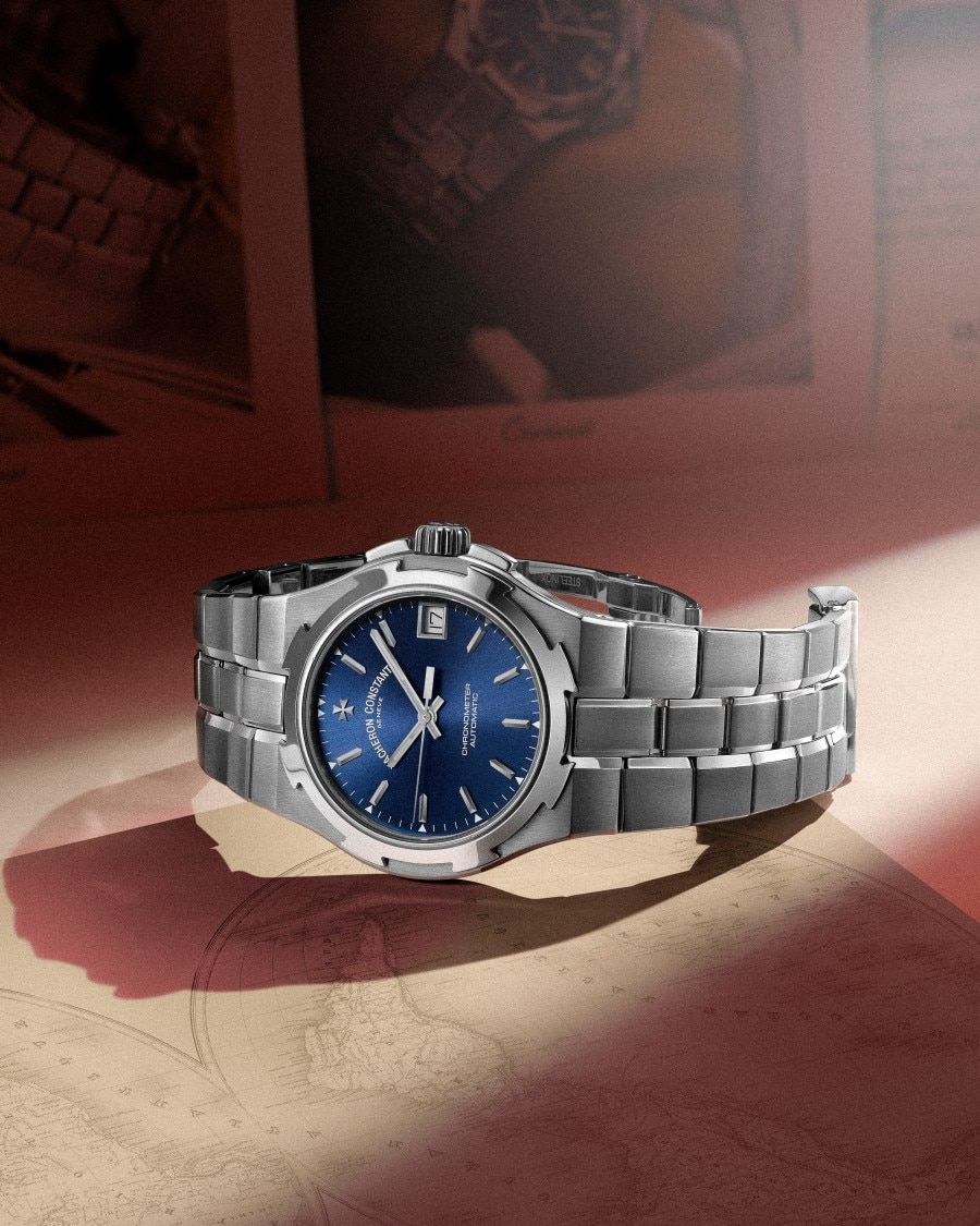 Steel Overseas watch lying on a paper map on a table