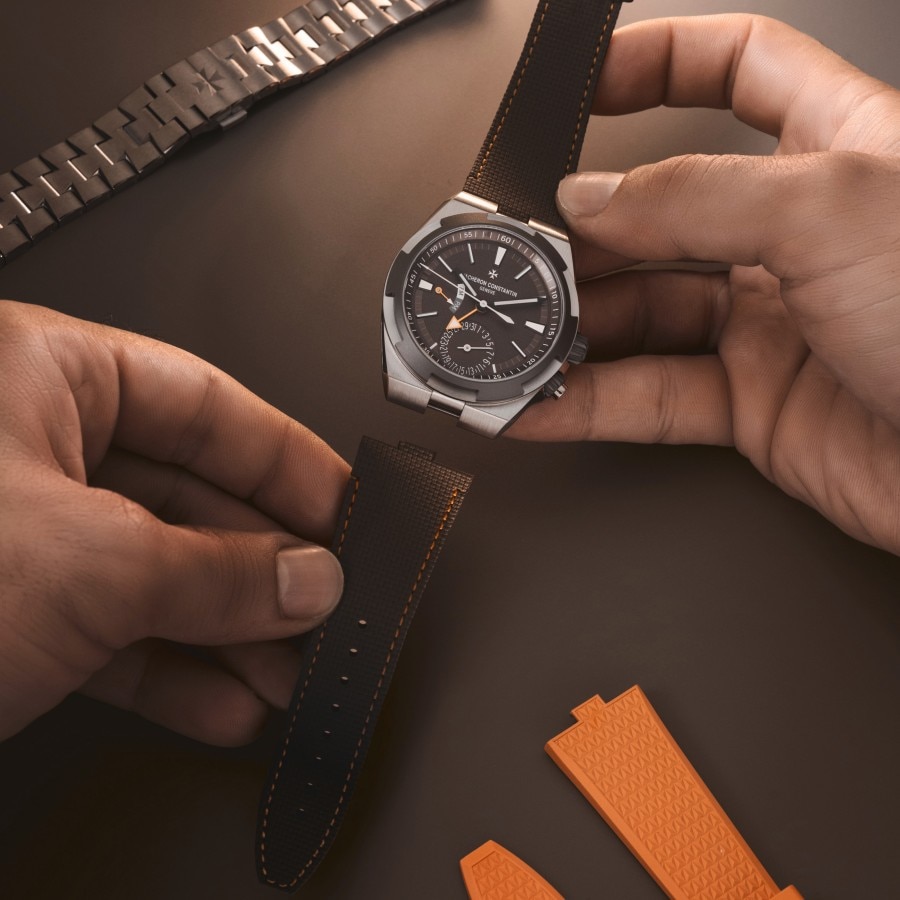 Person attaching a leather strap to an Overseas dual time Cardinal Points watch.