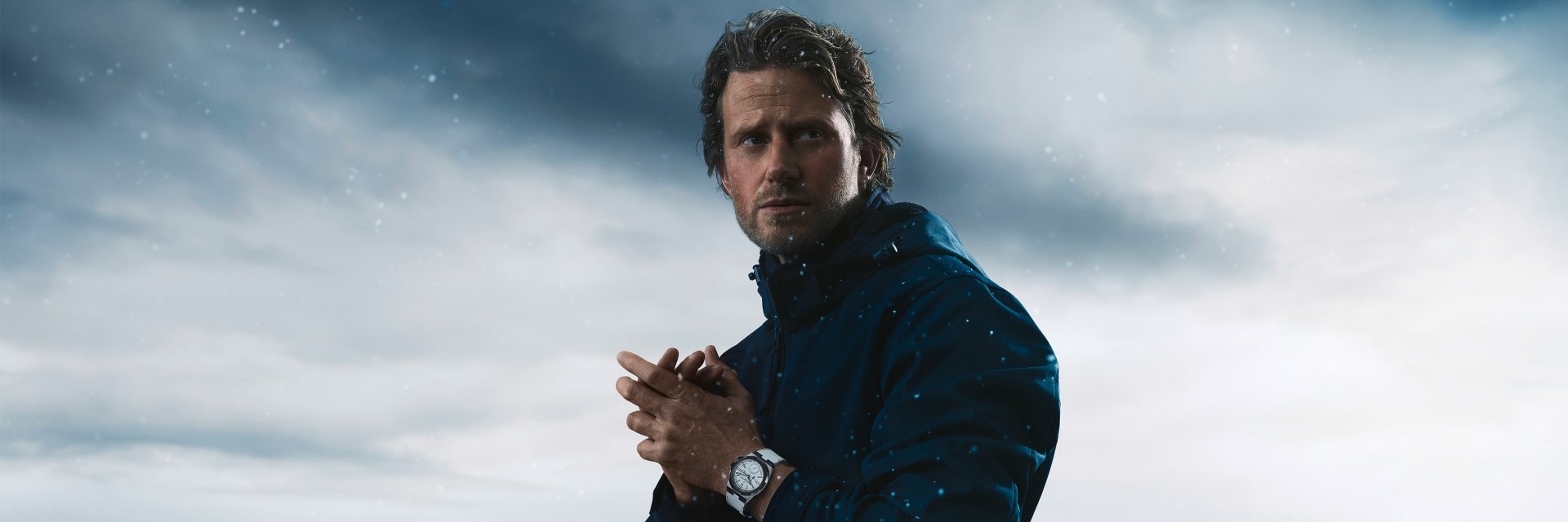 Cory Richards wearing the white Overseas Dual Time Cardinal Points watch with a snowy background