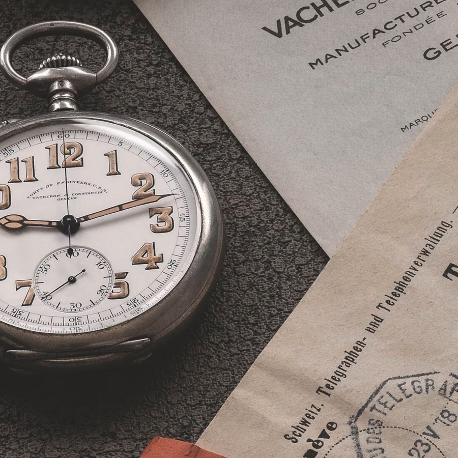 Round watch case with silver frame and large gold numbers