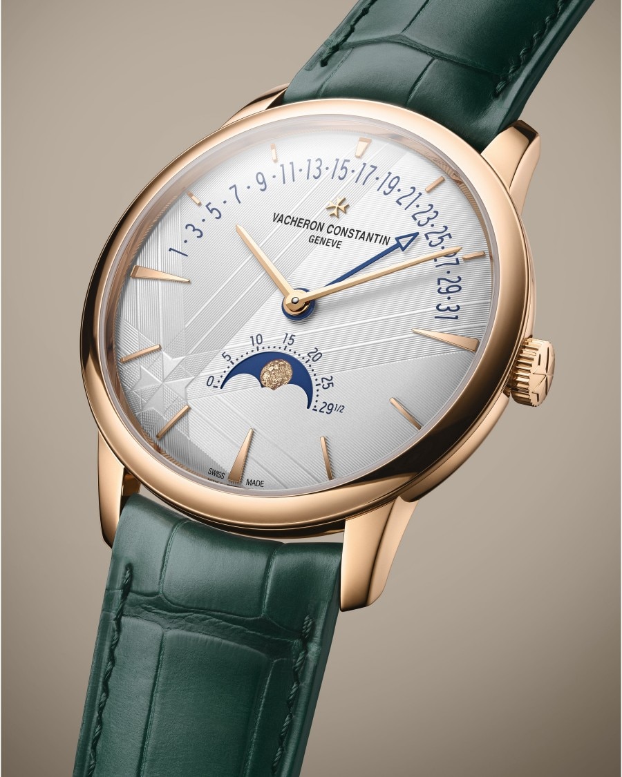 Patrimony - Moon Phase Retrograde Date A luxury wristwatch with a green leather strap, gold case, day-of-month markers, and a moon phase indicator.