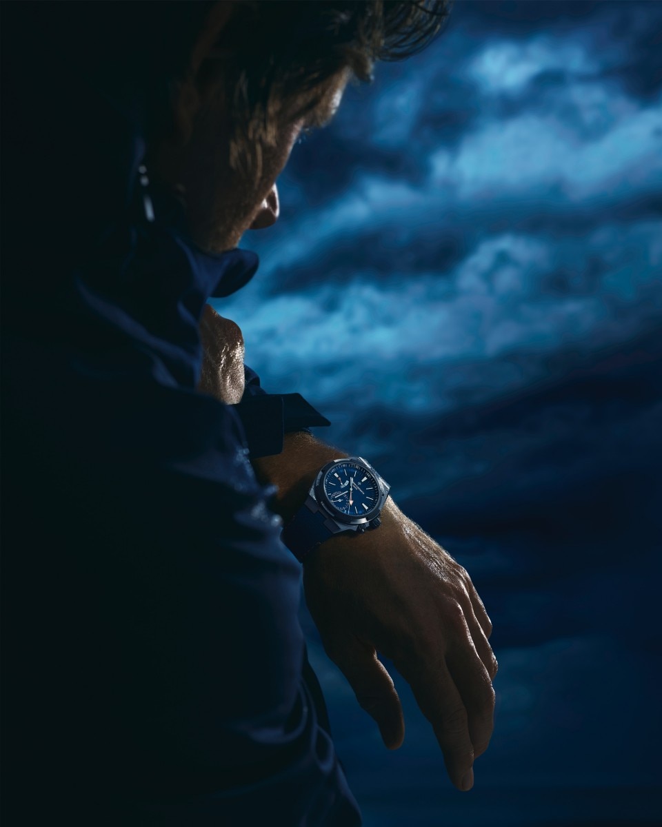 Cory Richards wearing the blue Overseas Dual Time Cardinal Points watch with a cloudy background