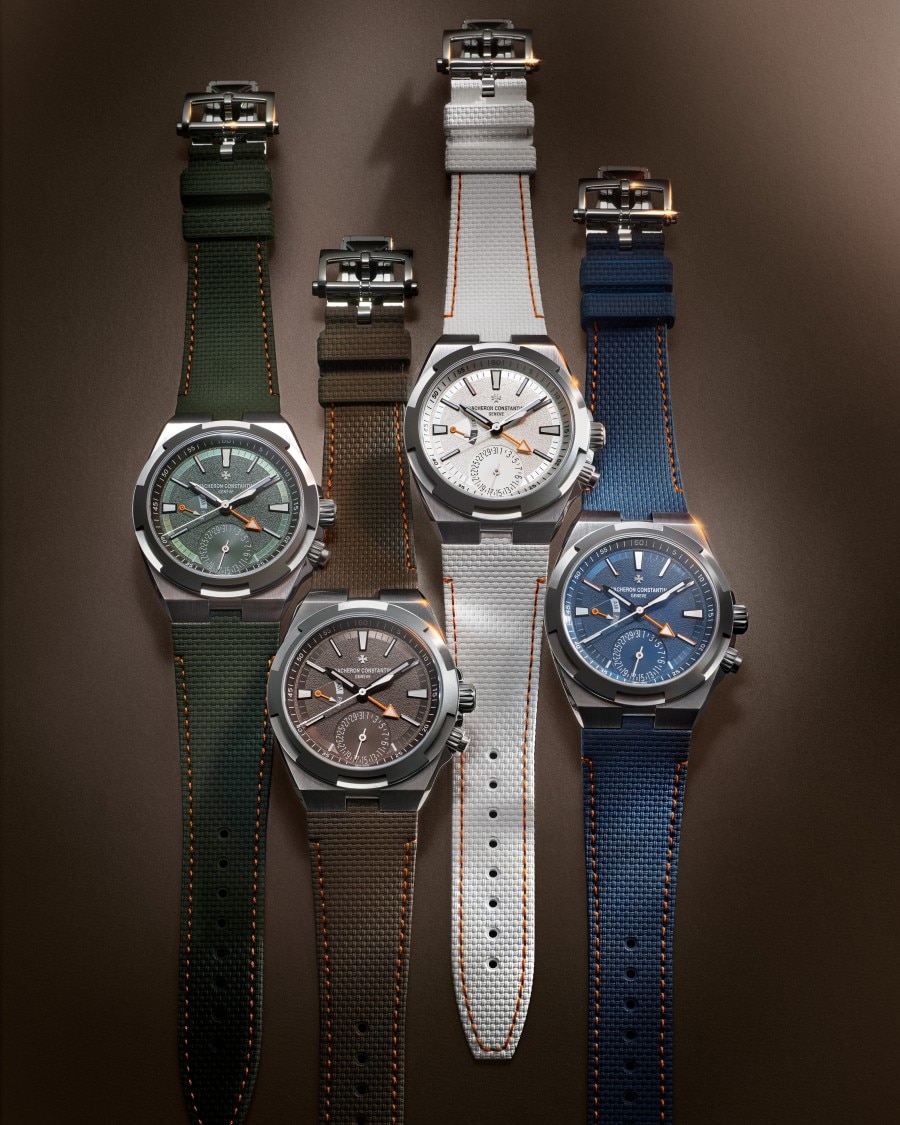 Four Overseas dual time Cardinal Points watch with different colored straps and dials on a dark background.