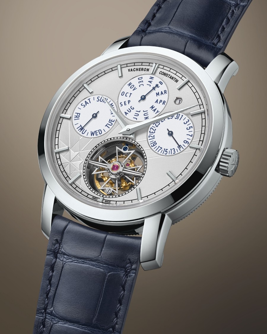 Traditionnelle - Tourbillon Perpetual Calendar A watch with a blue leather strap, silver case, multiple calendar sub-dials, and an exposed mechanism.