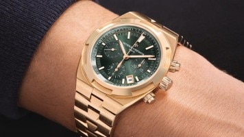 Gold Vacheron Constantin chronograph with a green dial worn on the wrist.