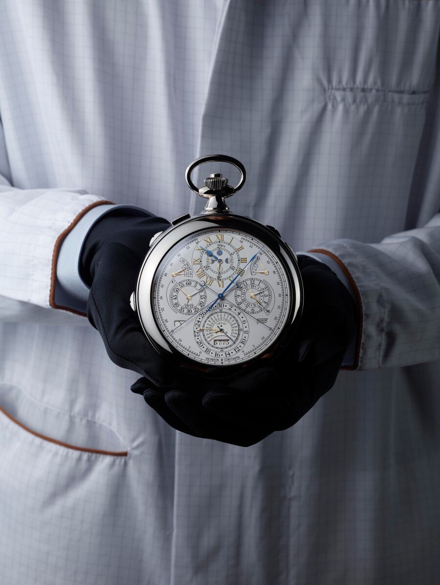 Hands wearing black gloves holding Reference 57260.