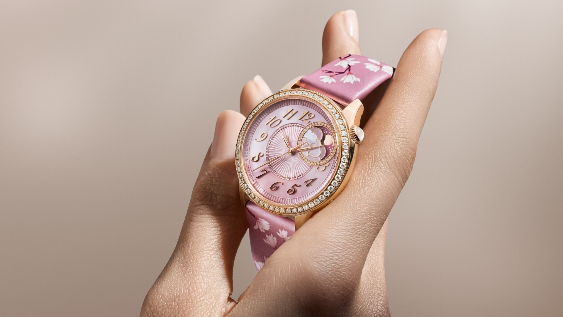 Egerie Moon Phase Spring Blossom watch highlighting the pink dial and diamond-set bezel.