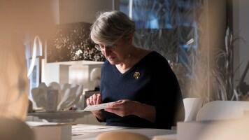 Artist precisely creating a paper crocodile concept watch.