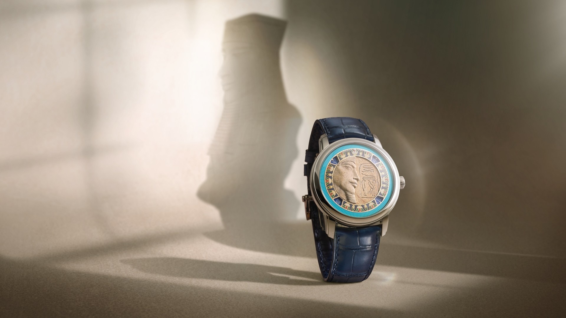 A watch featuring a pharaoh motif in its case on a light background.