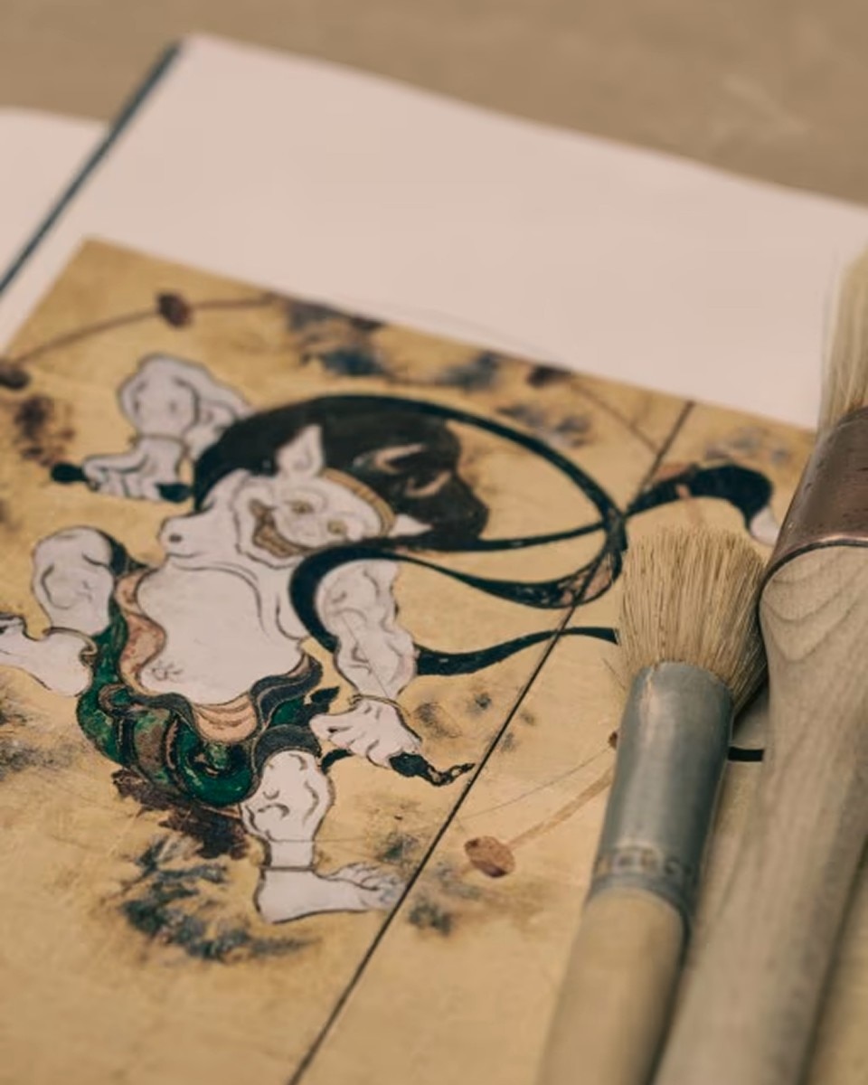 Traditional Japanese artwork showing a dynamic scene on paper.