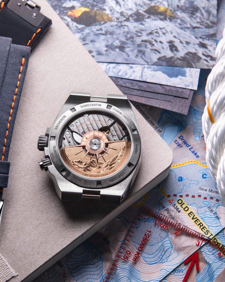 Open-face Vacheron Constantin watch with visible movement placed on sailing maps and gear.