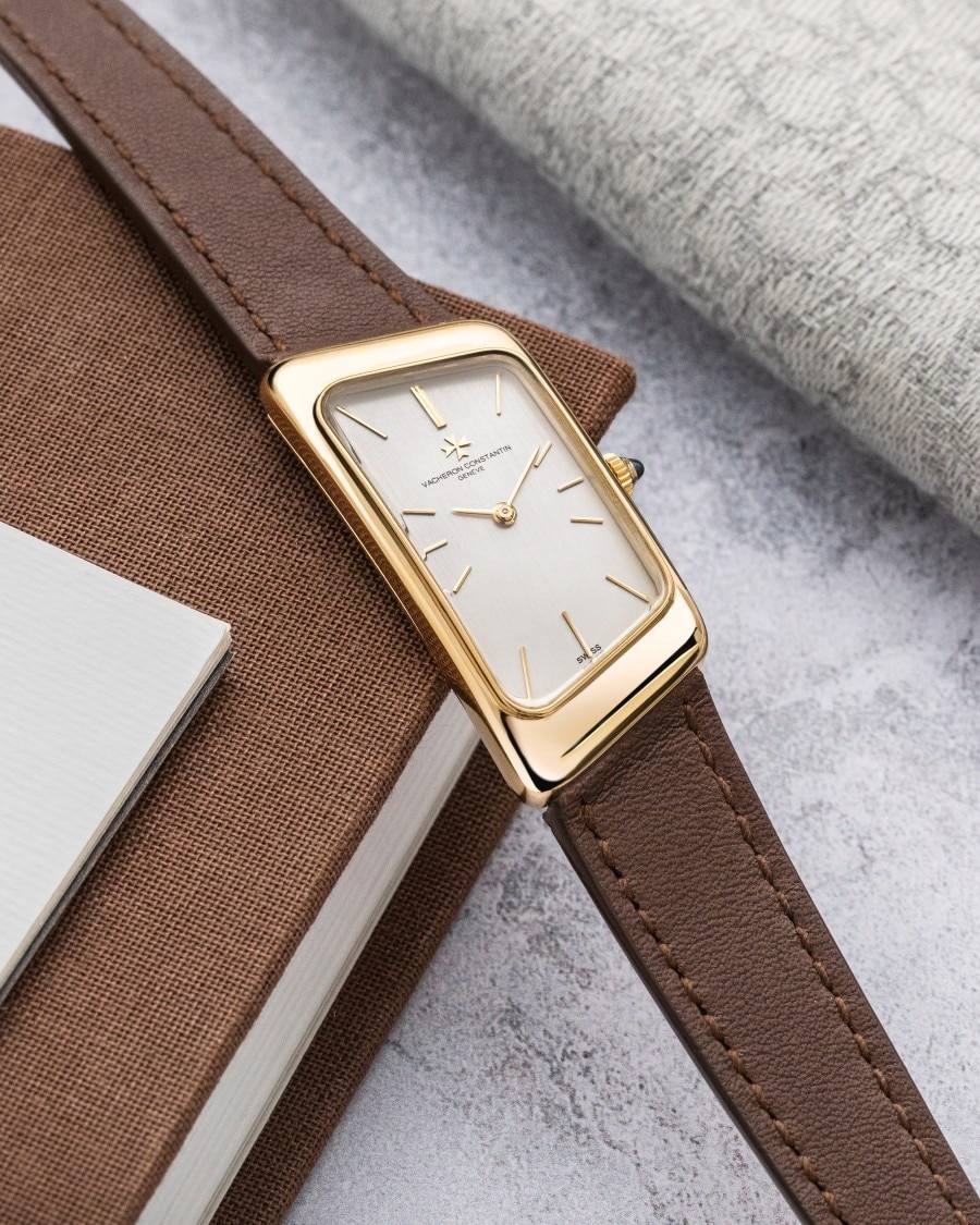 Les Collectionneurs - Prestige de la France A watch with a square case, gold details, a light crystal, and a brown leather strap.