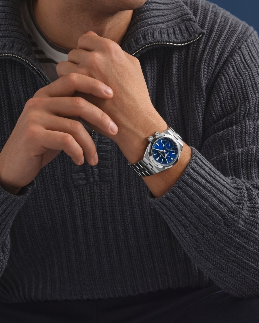  Man wearing a Vacheron Constantin watch with blue dial and silver strap.