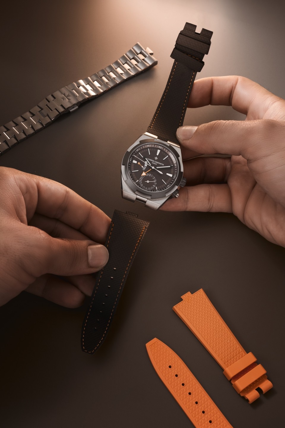 Person attaching a leather strap to an Overseas dual time Cardinal Points watch.