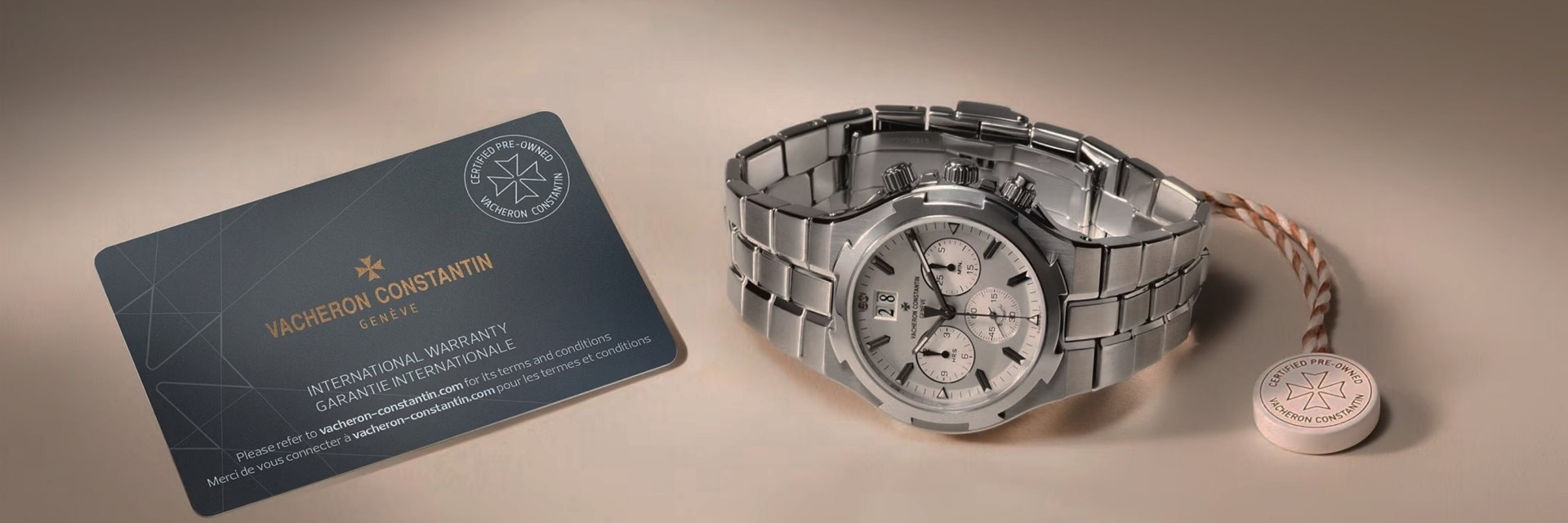 A dark rectangular card next to a silver metal watch.