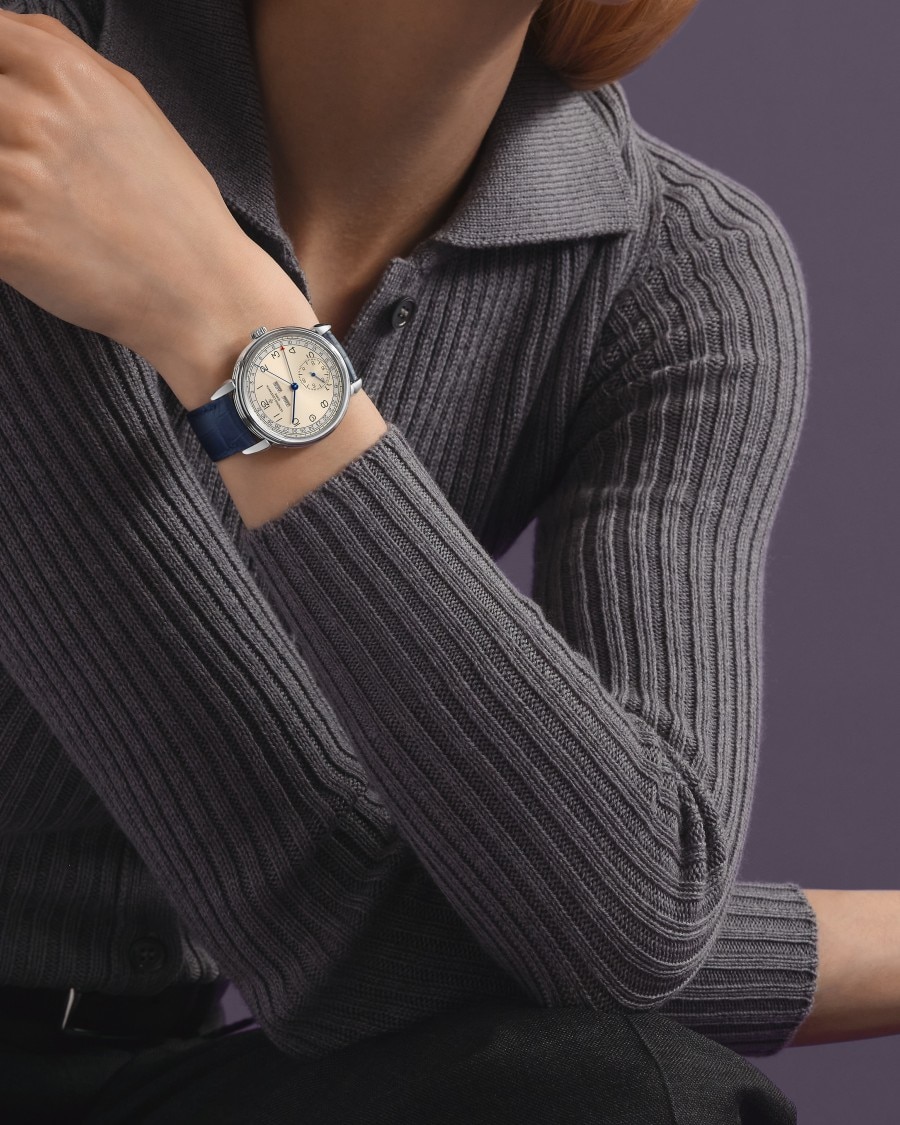  Historiques with white dial and leather strap on wrist.