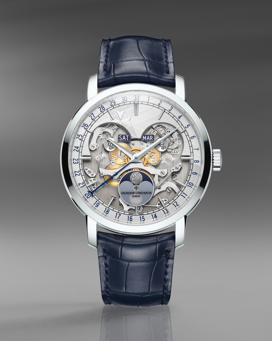 Traditionnelle Complete Calendar Openface High-end timepiece with an open-worked dial, calender complications, lunar phase display, and a blue leather strap.