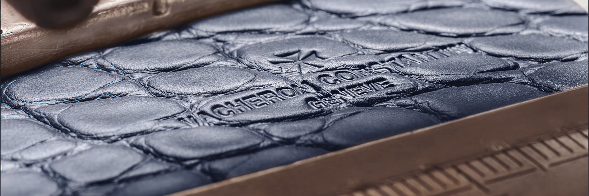 Close-up of a dark leather strap embossed with the Vacheron Constantin logo.