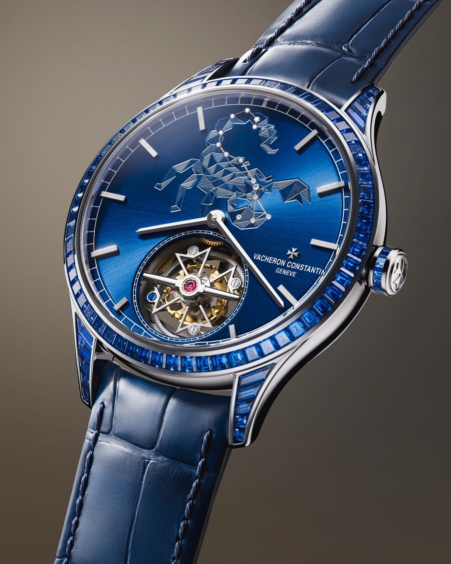 Métiers d'Art Tribute to The Celestial  An exclusive wristwatch with a blue dial featuring a scorpion motif and a sophisticated mechanical movement visible through an open window.