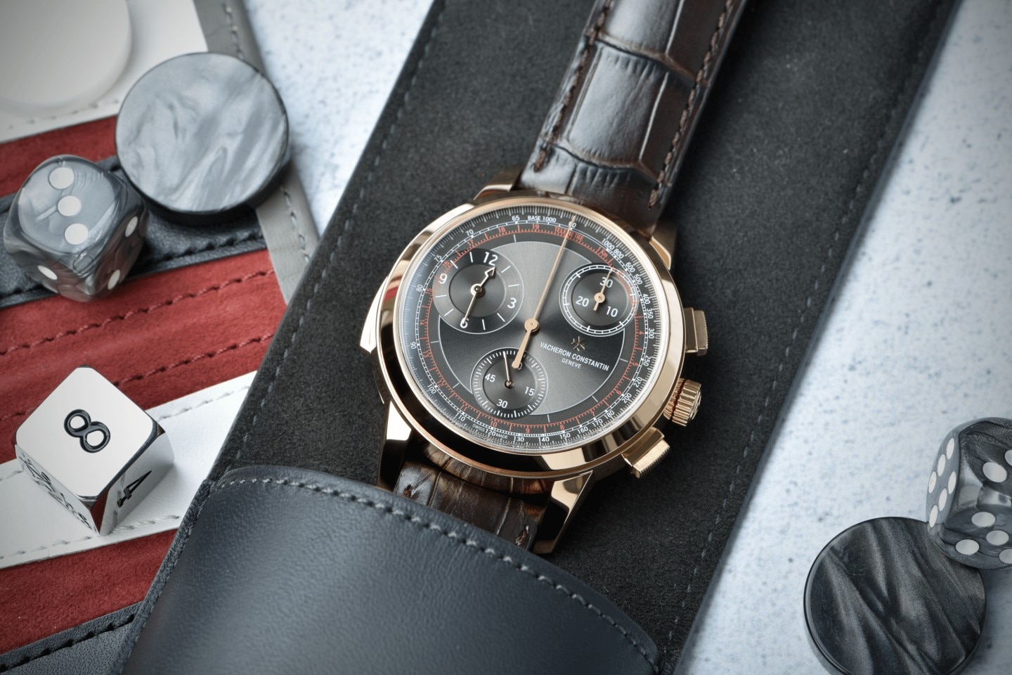 A Les Cabinotiers watch in a leather pouch with dices